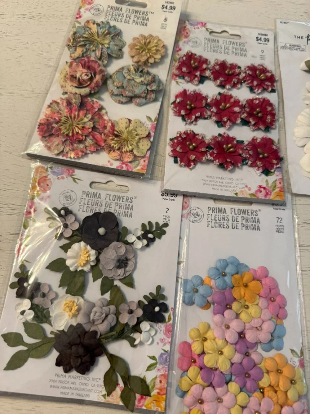 10 packages of fabric floral embellishments, NWT in beautiful colors